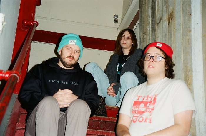 photo by alana wool malamiko sitting in a stairwell looking generally unamused.